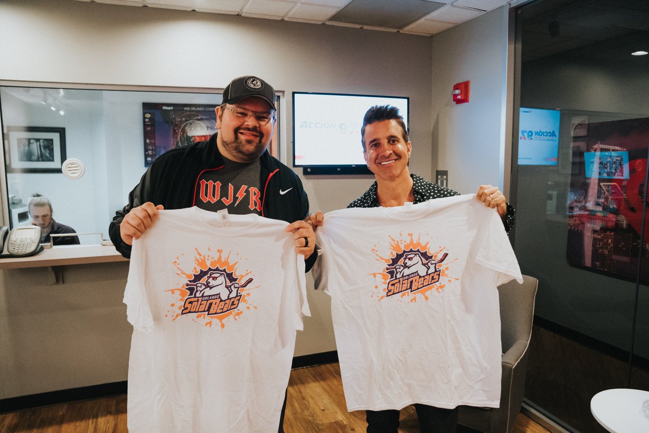 Bryan and Scott Stapp holding Orlando Solar Bears t-shirts at the iHeart studios