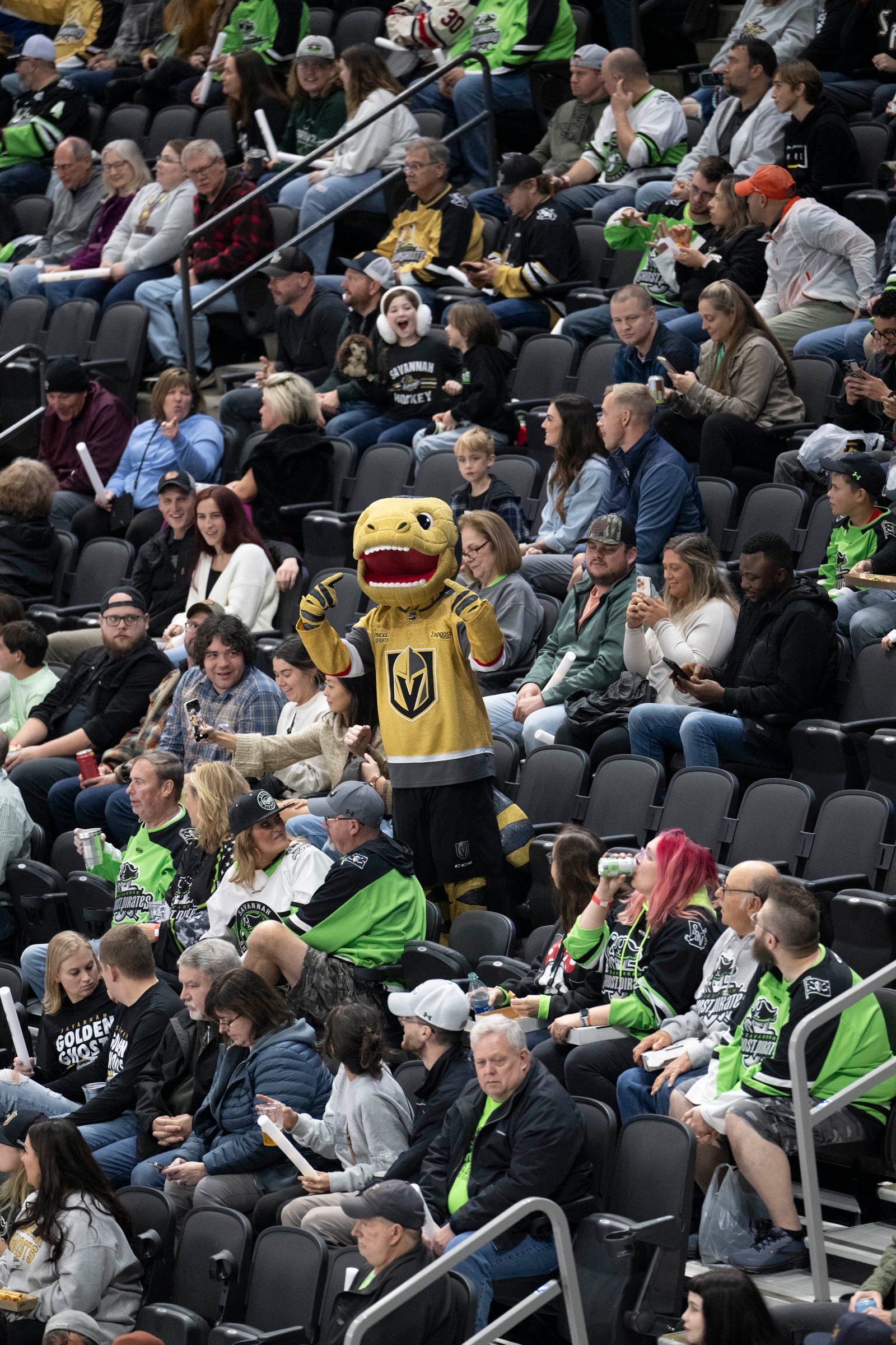 Golden Ghosts player Pedersen celebrating a goal in front of a roaring crowd